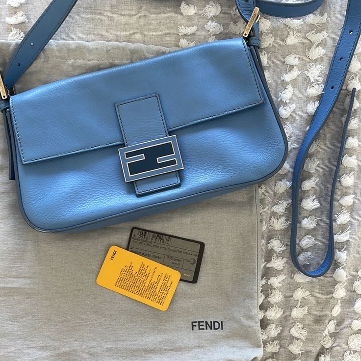 Baby Light Blue Fendi Baguette With Convertible Straps With Authenticity Card. Still Has Compact Mirror Wrapped In Plastic. Light Corner Wear On 2 Corners As Seen In Pics. Comes With Dust Bag, 2 Straps, Compact Mirror, Authenticity Card. Excellent Shape. Luxury Blue Baguette Bag, Luxury Blue Rectangular Baguette Bag, Designer Baguette Bag With Branded Hardware, Luxury Blue Baguette Bag For Everyday Use, Elegant Blue Baguette Bag With Detachable Strap, Elegant Blue Baguette Bag For Evening, Elegant Blue Baguette Bag With Removable Pouch, Elegant Blue Baguette Bag For Shopping, Designer Everyday Baguette Bag