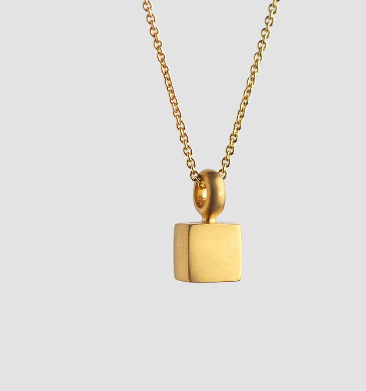 This small suitcase pendant hangs close to your neck. It can also sit on it's own, on the shelf, as though it had just come back from a journey. Materials: 22 karat gold. Pendant total length (include the bail): 12.7 mm. Cube width and length: 6.5 X 6.5 mm Inner diameter of the link: 3 mm. We can make it larger at your request. Whether around the neck, close to the heart, or lower - our pendants always hang close, rocking with us as we move. Their balance point is our balancing point. SHIPPING E Formal Necklace With Rectangular Pendant And Box Chain, Minimalist Pendant Charm Necklace For Formal Occasions, Minimalist Formal Jewelry With Square Pendant, Minimalist Pendant Charm Necklace For Formal Events, Minimalist Formal Necklaces With Rectangular Pendant, Modern Rectangular Necklace With Polished Finish, Minimalist Square Pendant Jewelry For Formal Occasions, Minimalist Rectangular Pendant Necklace For Formal Occasions, Minimalist Formal Pendant Charm Necklace