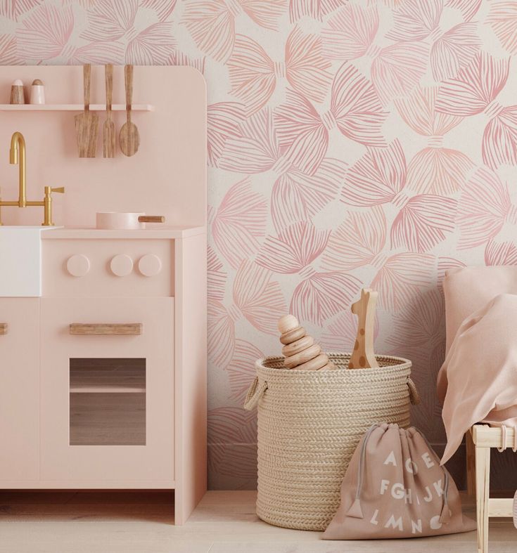 a pink and white room with an oven, toy storage basket, and wallpaper