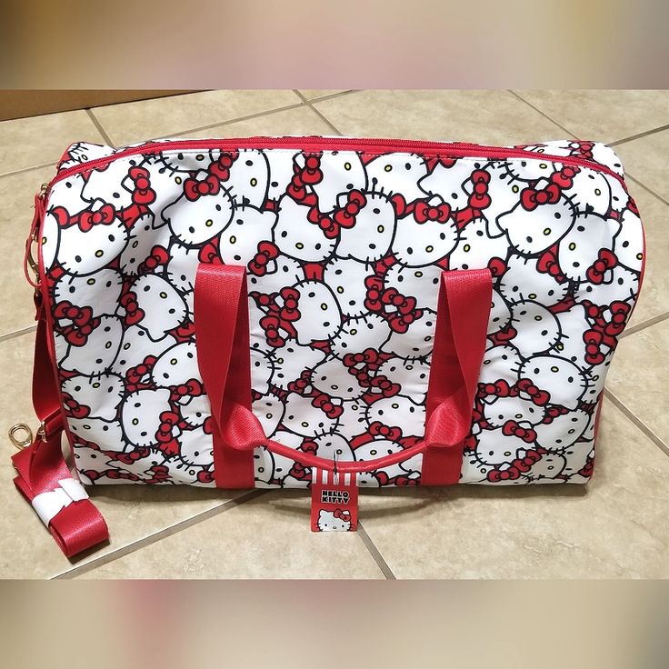 New With Tags Bioworld Sanrio Hello Kitty Red & White All Over Faces Duffel Bag. Measures About 20 Inches W X 12 Inches H X 9 Inches D. Top Zipper, Inner Zip And Slip Pockets, 2 Outer Side Slip Pockets. Outer Nylon Material. White Hello Kitty Print Bag, Hello Kitty Red Bag For Everyday Use, White Hello Kitty Print Shopping Bag, Red Hello Kitty Travel Bag, White Hello Kitty Shopping Bag, Cute Red Shoulder Bag With Zipper Closure, Red Hello Kitty Print Bag For Everyday Use, Red Hello Kitty Bag For Everyday Use, White Travel Bag With Hello Kitty Print