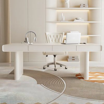 a white desk in front of a bookshelf