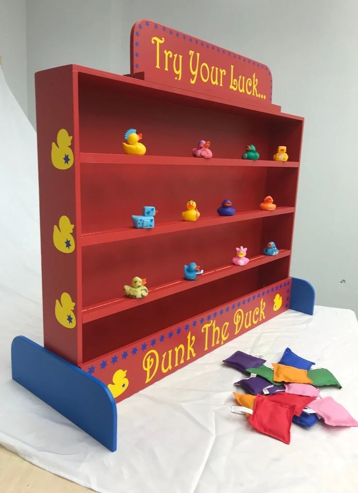 there is a red book shelf with rubber ducks on it and the words, try your luck drink the duck