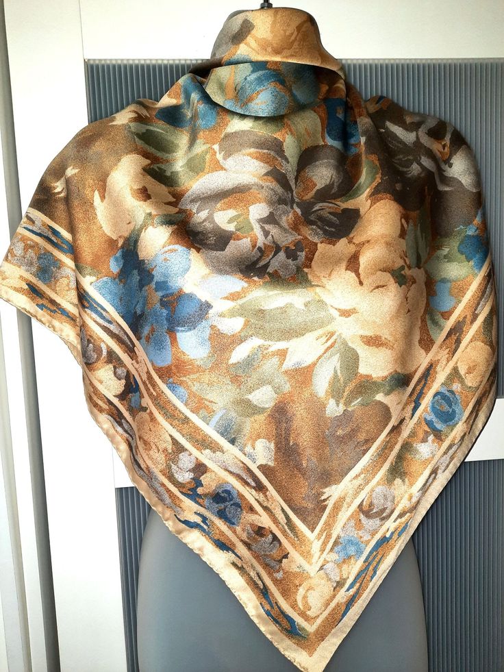 This is a large square scarf made in Italy. The scarf combines the pastel colors of  beige, brown, blue and green with a bold  floral design featuring amazing flowers in Victorian oil painting style. The scarf is 100% polyester but looks silk. The scarf is in excellent/mint condition and can be used as a wonderful gift. The scarf comes in a gift wrap and with a 'Thank you' card. For more scarves in my store visit: https://www.etsy.com/ca/shop/NostalgicByLiliya?ref=simple-shop-header-name&listing Vintage Blue Floral Print Scarves, Vintage Blue Silk Scarf For Spring, Blue Vintage Silk Scarf For Spring, Elegant Beige Silk Scarf With Floral Print, Vintage Multicolor Floral Print Shawl, Beige Floral Print Scarves For Spring, Beige Floral Print Scarf For Spring, Italian Silk Scarf, Large Square Scarf