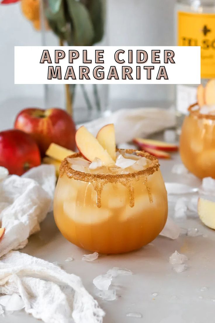 apple cider margarita is served in glasses with apples and cinnamon on the side for garnish