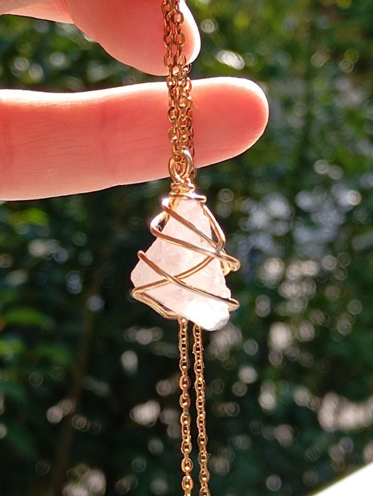 Beautiful dainty necklace with tiny raw rose quartz - genuine gemstone,  Random hand wrapped raw crystal with gold plated copper wire high quality. It comes with gold plated stainless steel chain and organza gift bag. beautiful gift for girlfriend  Please note that no two crystals are alike, therefore shape and size may slightly. ✧ Crystal size approx 1,5~2*1,2~1,5cm. ✧ Each crystal chosen with care and handled with loving intention. bohemian finding, gorgeous necklace elegant necklace, healing Rose Quartz Pendant Necklace, Rose Quartz Necklace Pendants, Handmade Gemstone Jewelry, Quartz Pendant Necklace, Raw Rose Quartz, Protection Crystals, Healing Necklace, Rose Quartz Pendant, Protection Necklace