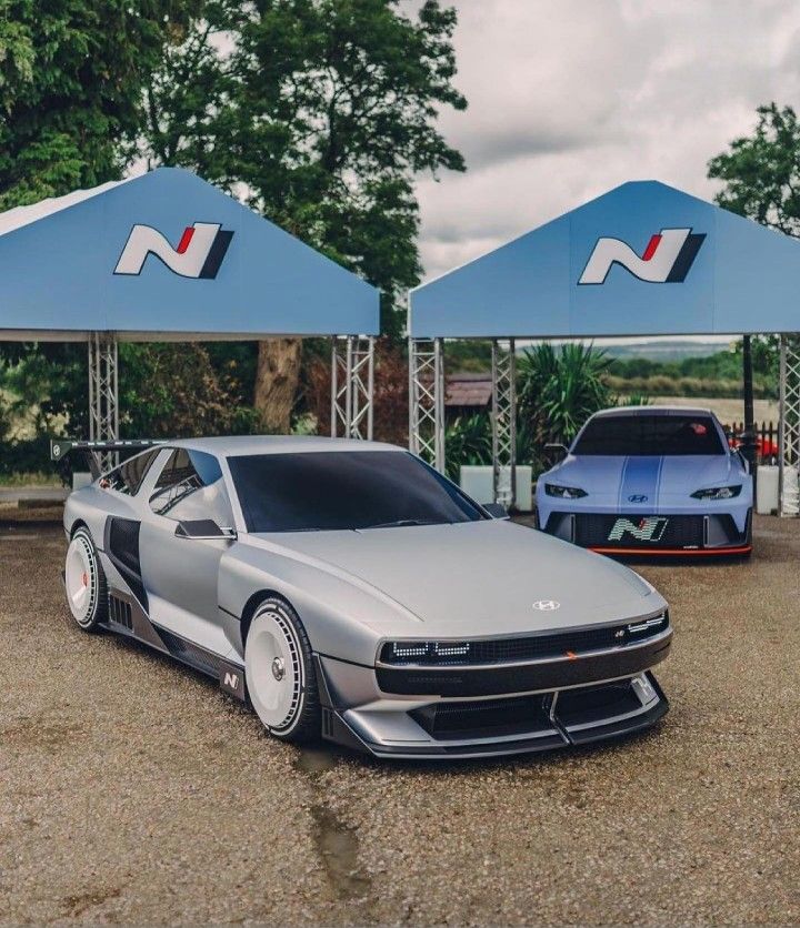 two cars parked in front of some blue tents