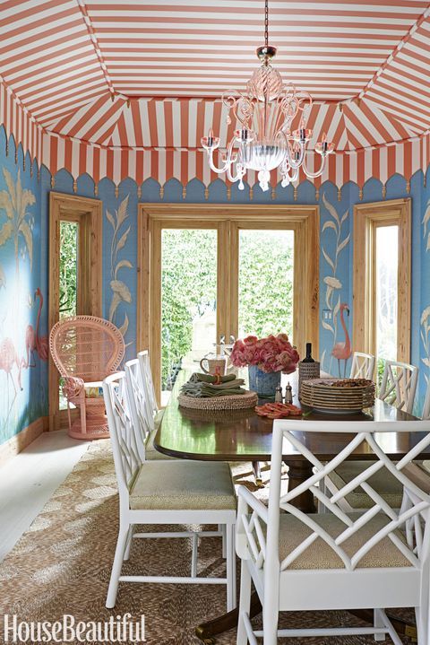 the dining room is decorated in blue and orange with flamingos painted on the walls