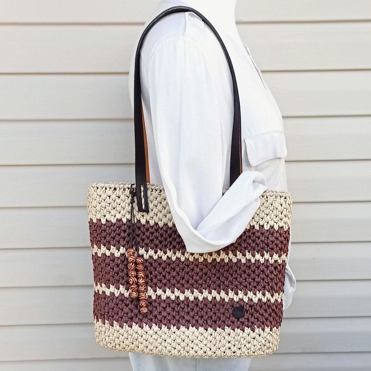 This raffia tote is a crochet straw bag with leather handles. The handmade raffia bag is great choice for every day in the summer, on the beach or on vacation. Its a great gift ideas. The beige and brown  summer tote bag have a faux leather bottom and handles. Clasp - magnetic button. Inside the bag is lining of high quality cotton. There are inside pockets, one of them with a zipper. Be unique. It`s a handmade bag, there is no two exactly the same bags in the world! DETAILS: - length 35cm/14 in Casual Tote Shoulder Bag In Paper Straw, Casual Paper Straw Tote Shoulder Bag, Natural Color Crochet Bag With Woven Leather, Natural Colored Crochet Bag With Woven Leather, Eco-friendly Jute Crochet Bag With Woven Leather, Eco-friendly Crochet Jute Bag With Woven Leather, Eco-friendly Crochet Bag With Woven Leather Details, Eco-friendly Crochet Bag With Woven Leather, Bohemian Straw Bag With Braided Handles For Everyday