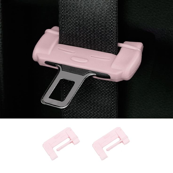 two pink clips are attached to the back of a black seat belt and one has a metal clip on it