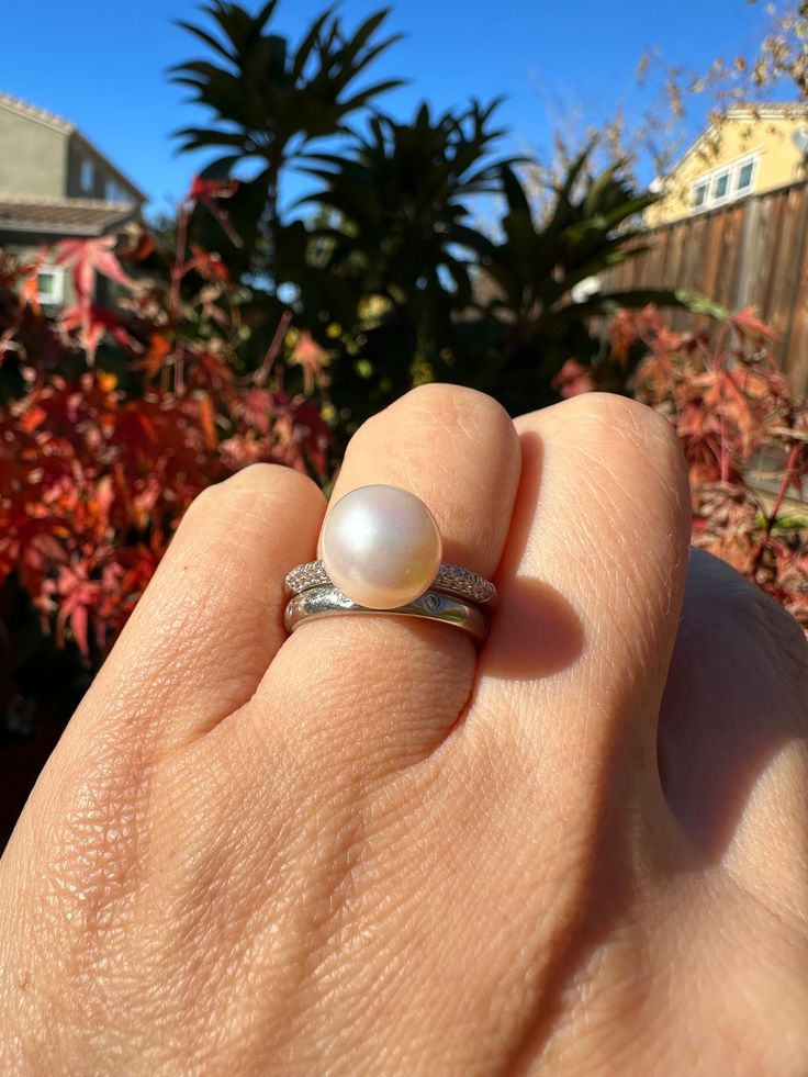 White Freshwater Natural Pearl S925 Silver Ring ,  non-nucleated pearl Pearl Size: 10.3x10.0x10.4 mm Ring Size: US Size 7.5 (adjustable 7 - 8.5)   This is an untreated, no dye freshwater natural pearl.   Please check the pictures very closely.  Pearls have blemish, imperfection and spots.   The pictures was taking under the sun light or under the shade.  I was using iPhone 14 default setting to take all the pictures.  No enhancement was done on the pictures.  Physical pearls are very close to the picture images.   More pictures will be provided upon request. All these pearls are non-nucleated; that is, they are composed almost entirely of nacre.  They are solid pearl with no internal bead nucleus.  These pearls are solid and durable.   Freshwater Pearls: There are two different types of cu Silver Akoya Pearl Ring With Pearl Drop, Elegant Round Hypoallergenic Pearl Ring, Elegant Hypoallergenic Round Pearl Ring, Elegant White Hypoallergenic Pearl Ring, Elegant Hypoallergenic Pearl Ring, Silver Akoya Pearl Ring, Silver High Luster Pearl Ring For Anniversary, Classic Adjustable Pearl White Pearl Ring, Silver Pearl Ring With High Luster