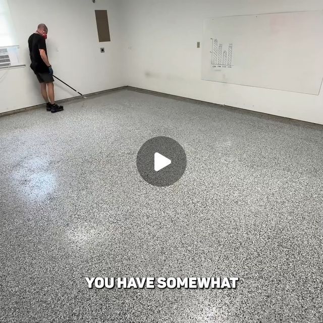 a man with a mop in an empty room