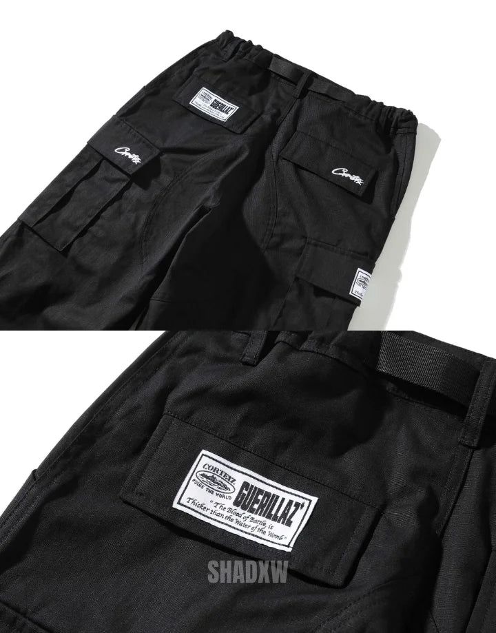 Type: Techwear pants Design: Techwear, streetwear Technical pants: This techwear pants is the perfect garment to complete your Techwear outfit. Premium quality: Reinforced seams, comfortable to wear, soft touch Materials: Polyester Machine washable: 30 °C (86 °F) Size Length Hip Waist Cuffs Height Weight M 100 112 72-80 37 165-175cm 50-60kg L 102 116 76-84 38 170-180cm 55-65kg XL 104 120 80-88 39 175-185cm 60-75kg 2XL 106 124 84-92 40 180-190cm 75-80kg Embodying the Essence of London Streetwear Techwear Wide Leg Cargo Pants For Streetwear, Wide Leg Techwear Cargo Pants For Streetwear, Urban Pants For Outdoor Activities With Side Pockets, Functional Black Cotton Bottoms, Straight Leg Sweatpants With Cargo Pockets For Streetwear, Straight Leg Sweatpants With Multiple Pockets For Streetwear, Sporty Cargo Pants For Streetwear, Sporty Pants With Pockets For Streetwear, Straight Leg Cargo Sweatpants For Streetwear