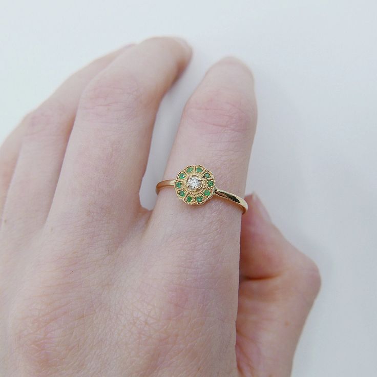 This "Flora" ring has a bit of old world charm to it, the pop of color from the emeralds surrounding the diamond really bring this ring to life. Like your very own bit on mother nature on your finger. This Flora ring is also a great addition to your everyday ring collection, and can be stacked to perfection! Details: 14k Gold (options to choose from: yellow, rose or white) Available in sapphire, ruby, emerald, or diamond options. This ring can come in a half diamond pave band upon request (pleas Rose Gold Emerald Ring, Mothers Day Gift Ideas, Pave Diamond Band, Everyday Ring, Pave Band, Ruby Emerald, Ring Collection, Everyday Rings, Old World Charm