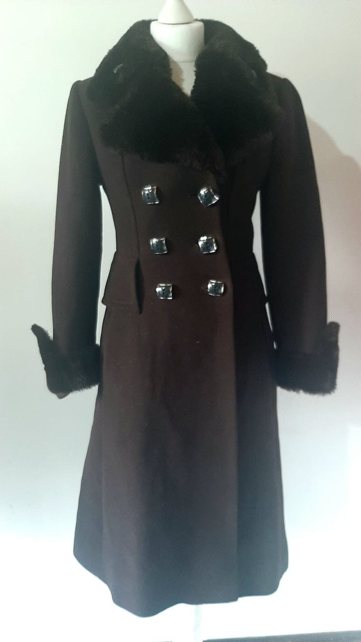 This stunning vintage women's '90s does '70s chocolate brown double-breasted overcoat is perfect for the winter.  Comes in a long-length A-line style Features: - double breasted  - faux fur cuffs & full collar - hip welt pockets - large navy blue squared buttons Condition: Immaculate condition Sizing: label reads 36, please ask for measurements before purchasing if you are unsure! Fitted Brown Long Pea Coat, Brown Double Button Closure Pea Coat For Winter, Brown Double Button Pea Coat For Winter, Brown Buttoned Pea Coat For Winter, Brown Winter Pea Coat With Double Button Closure, Brown Pea Coat With Buttons For Winter, Winter Brown Pea Coat With Double Button Closure, Brown Long Pea Coat For Winter, Brown Winter Pea Coat With Buttons