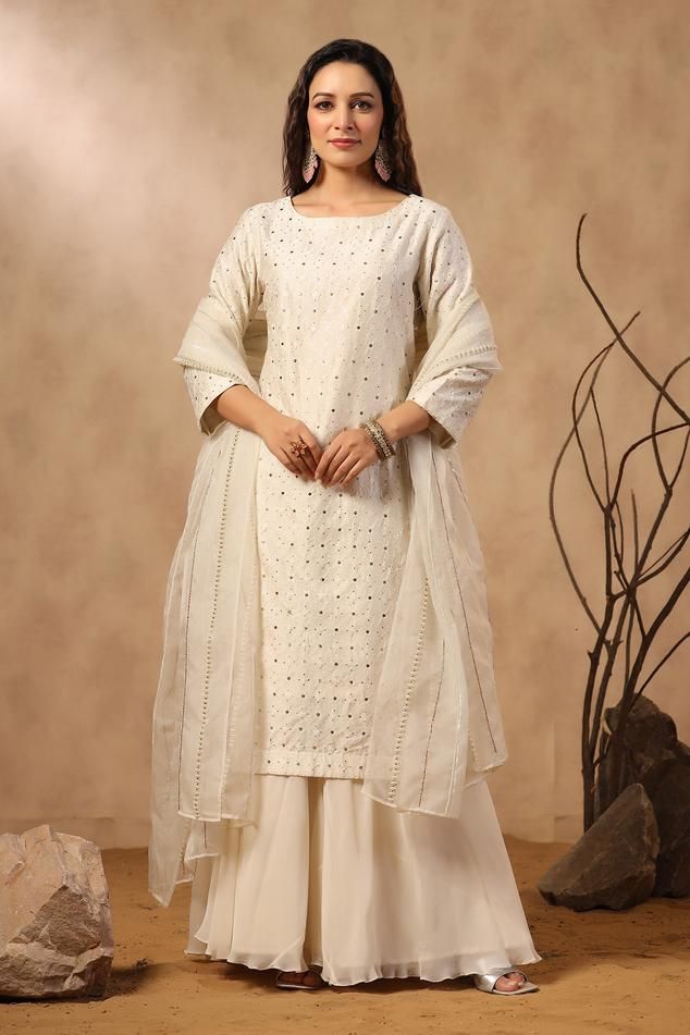 White silk kurta with floral jaal pattern embroidery. Comes with sharara and embroidered dupatta.
Components: 3
Pattern: Embroidered
Type Of Work: Floral Jaal, Sequins, Pearls, Cutdana
Neckline: U Neck
Sleeve Type: Three Quarter
Fabric: Kurta: Silk, Sharara: Georgette, Dupatta: Organza
Color: White
Other Details: 
Attached lining
Approximate product weight: 0.5-1 kg
Occasion: Sangeet - Aza Fashions Dola Silk Palazzo Set With Mirror Work, Festive Off White Straight Kurta Set, Festive Off White Sets With Straight Kurta, Festive Off-white Sets With Straight Kurta, Chanderi Sharara With Resham Embroidery, Elegant Cotton Sharara With Straight Kurta, Unstitched Off White Sharara With Resham Embroidery, Elegant Cotton Palazzo Set With Zari Work, Off-white Zari Work Straight Kurta Set