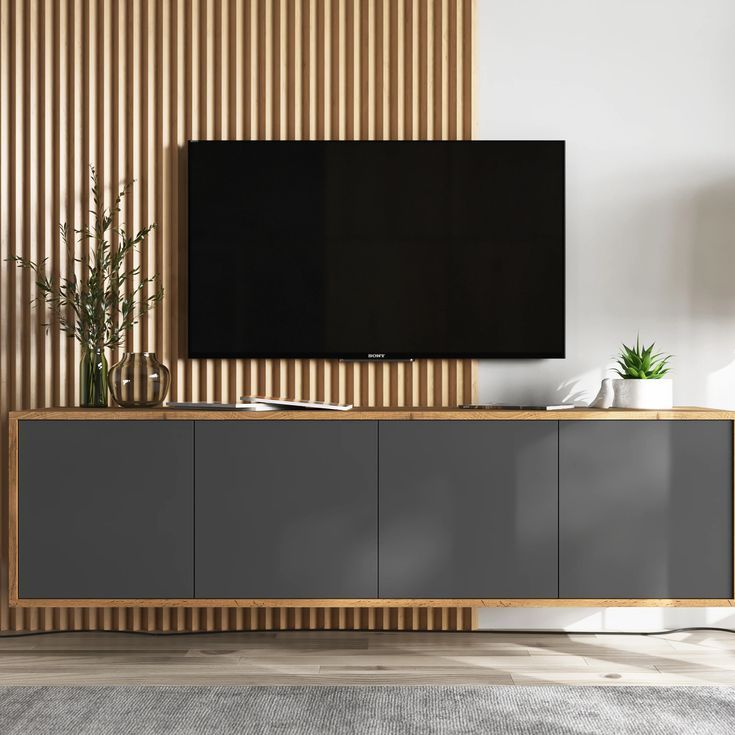 a flat screen tv sitting on top of a wooden cabinet