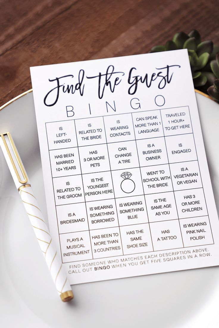 a white plate with a gold pen on it and a game for the guests to play