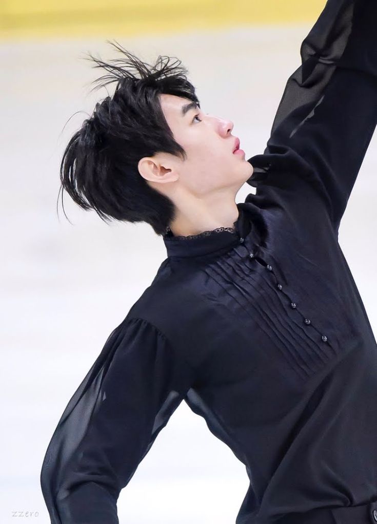 a woman in black is performing on the ice