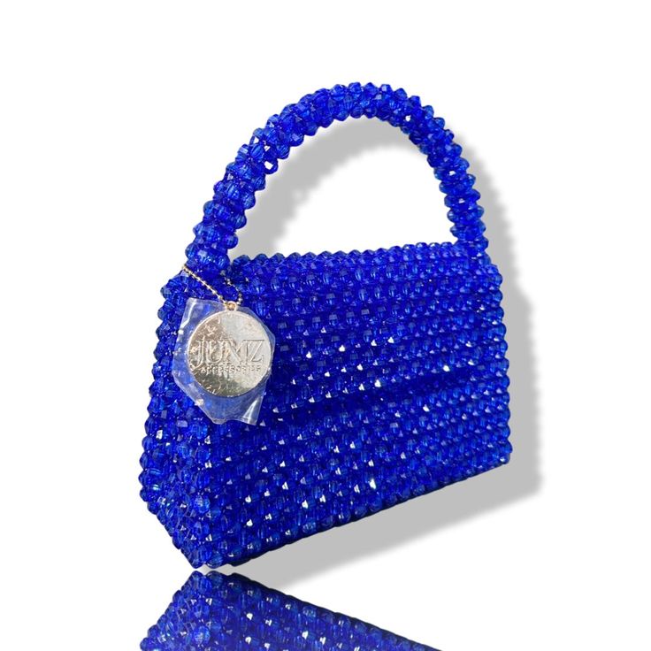 Artisan Beaded Handbag.Designed in NYC. Crafted with precision in the heart of Lagos, Nigeria.Elevate your style with our exquisite beaded handbags – a timeless accessory that seamlessly blends sophistication with versatility. Meticulously handcrafted, these bags are built to withstand the test of time. Whether paired with a cocktail dress, jeans and a tee, professional attire, or your favorite clubwear, our bead bags effortlessly complement any ensemble. Dress Jeans, Lagos Nigeria, Beaded Handbag, Professional Attire, Detail Shop, Timeless Accessories, Beaded Bags, The Test, Contemporary Fashion