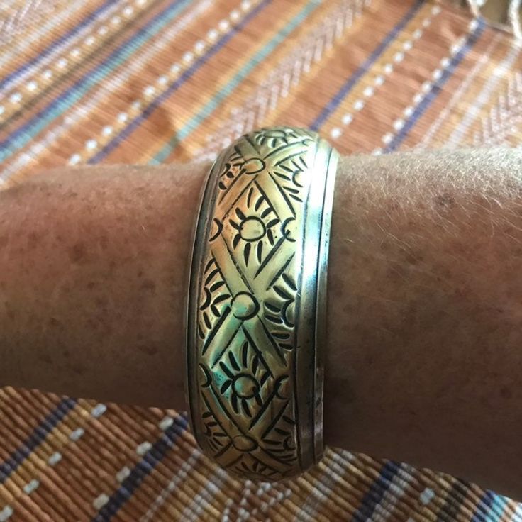 Vintage brass bracelet has silver plating on inside and over edge. Beautiful tribal design will look nice to offset black attire or blend well with Southwest or other ethnic clothes. Inside of bangle measures 8 inches around. It is 1 1/4 inch wide and about 1/2 inch high. A fun boho vintage bracelet. Would make an unique gift. Vintage Gold Bracelets With Oxidized Finish, Traditional Gold Bracelets With Oxidized Finish, Traditional Gold Bracelet With Oxidized Finish, Bohemian Gold Etched Cuff Bracelet, Gold Bohemian Etched Cuff Bracelet, Bohemian Brass Bracelets For Festivals, Bohemian Metal Bangle With Intricate Design, Silver Brass Bangle With Intricate Design, Bohemian Metal Bangle With Engraved Details