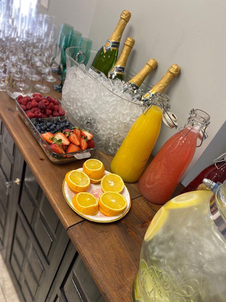 there are many different types of fruit on the counter top, including oranges and raspberries