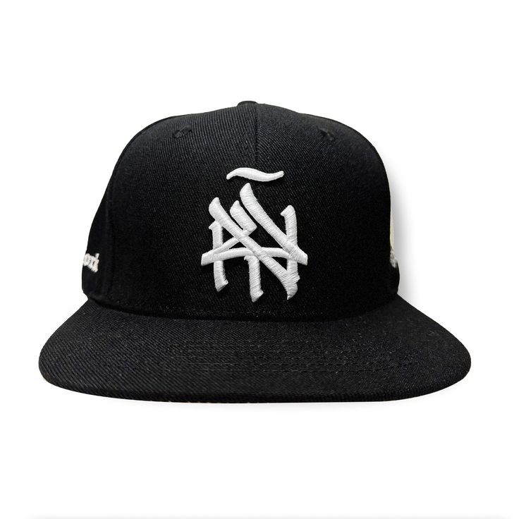 Introducing our New York (ÑY) Hometown Logo Snapback Hat – featuring our remixed 3d embroidered logo with a tilde design on the front, under brim is gray, the right side features our Nueva York "Split Logo" design and the left side highlights a "Latinos Unidos" emblem with flags from Colombia, Puerto Rico, Dominican Republic and Mexico. Our “NY Hometown Logo” intertwines the "N" and "Y," inspired by the Yankees and Mets interlocking insignias; merging classic sports heritage with a handmade, sty Gray Hat With Embroidered Logo For Streetwear, Black Hats With Embroidered Logo For Streetwear, Gray Baseball Cap With Embroidered Logo For Streetwear, Streetwear Trucker Hat With Embroidered Logo And Short Brim, Streetwear Trucker Hat With Short Brim And Embroidered Logo, Streetwear Hats With Embroidered Logo And Short Brim, Short Brim Hats With Embroidered Logo For Streetwear, Black Hip Hop Fitted Hat For Streetwear, Adjustable Gray Snapback Hat For Streetwear