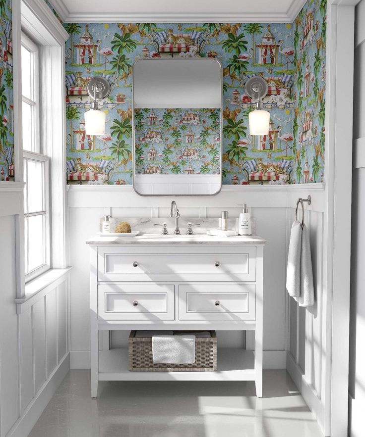 a white bathroom with floral wallpaper and mirror