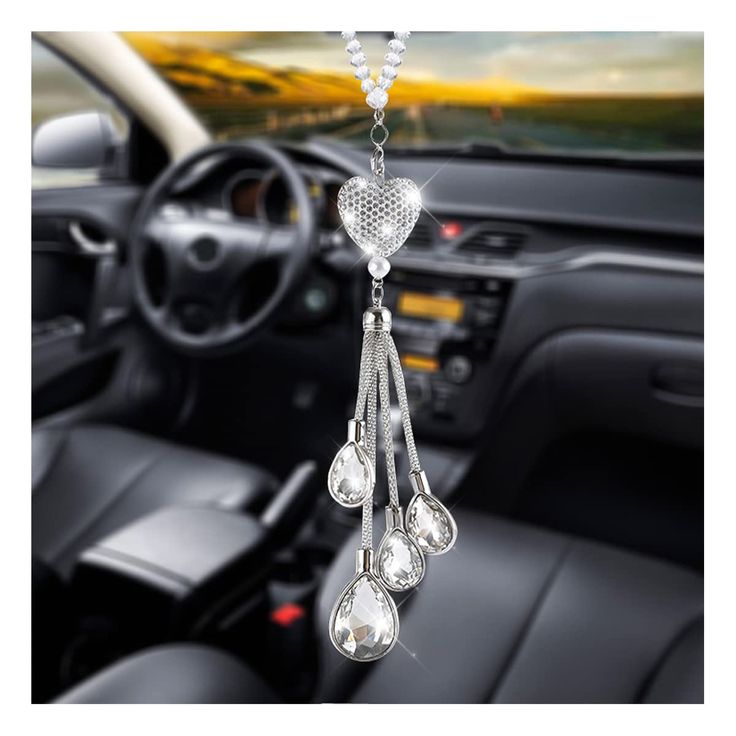 the interior of a car is decorated with crystal beads and hanging from it's center console