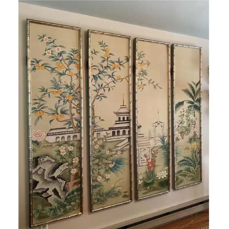 four panels with paintings on them in a room