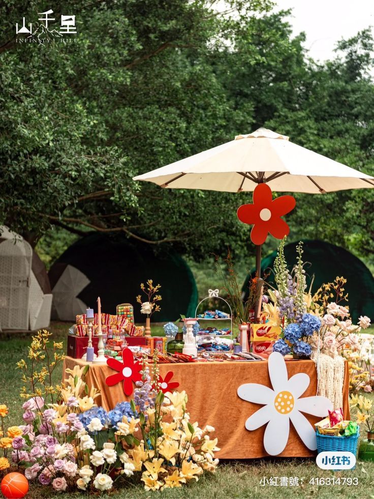 a table with an umbrella and flowers on it