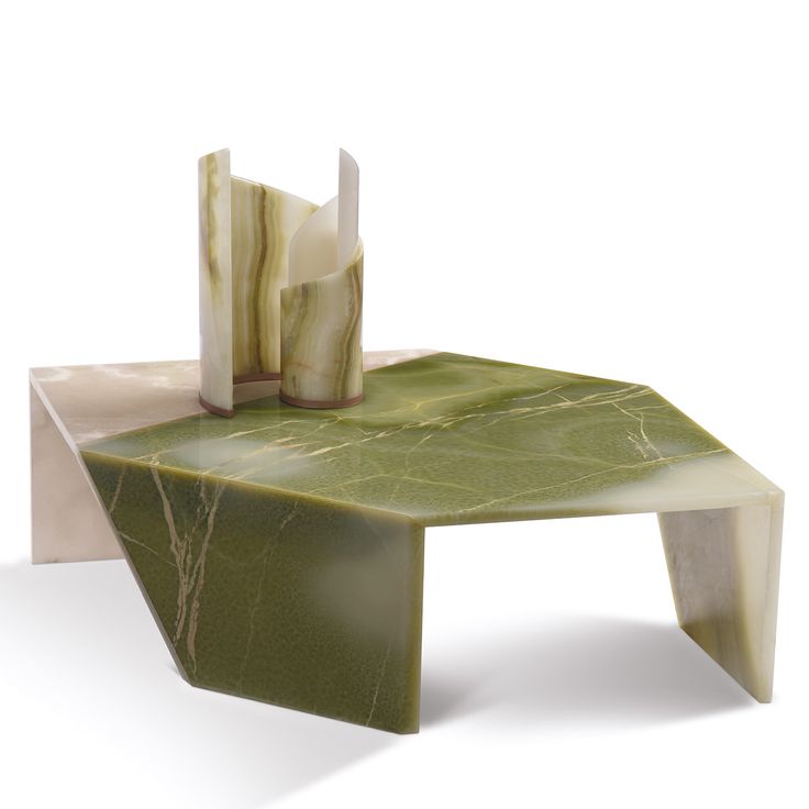 a table made out of marble and green leafy material