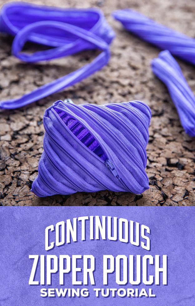 a purple object sitting on top of a stone floor next to a blue sign that says continuous zipper pouch