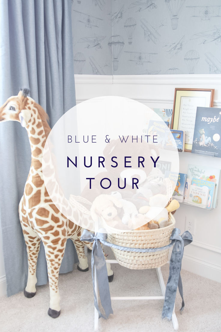 a baby's nursery with a giraffe toy and blue and white nursery tour sign