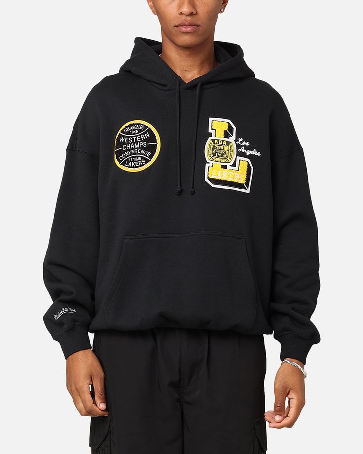 Get a slam dunk in the Los Angeles Lakers Conference Hoodie. This hoodie is decked out in embroidered team graphics to rep your fave team with chenille appliqués to give you that luxary streetwear feel. Finished off with ribbed trims to give you that super cosy fit when you're supporting the team you love. Don't miss out and grab yours today at Culture Kings. - Official merchandise - Embroidered brand graphics - Chenille appliqués - Hood - Adjustable drawstring - Kangaroo pocket - Dropped should Brand Graphics, Slam Dunk, Culture Kings, Black Culture, Mitchell & Ness, Los Angeles Lakers, Unisex Style, Formal Occasion, Unisex Fashion