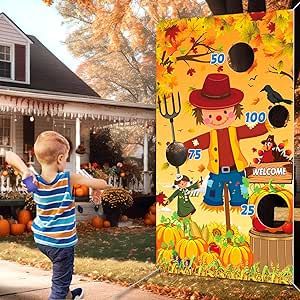 a young boy standing in front of a halloween yard decoration