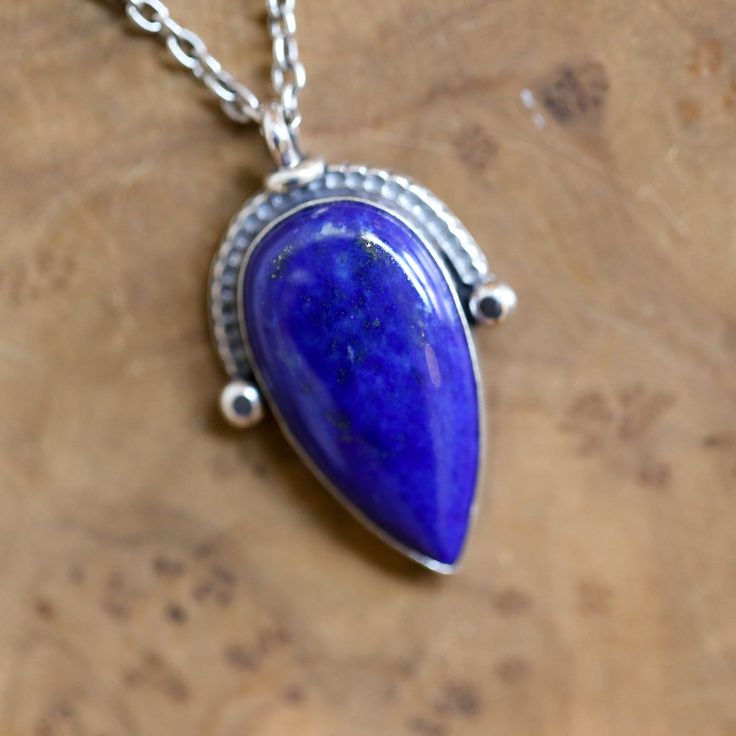 This listing is for our new Compass Pendant in rare quality, AAA Deep Blue, Pear Shaped, Lapis Lazuli, and .925 Sterling Silver. This Ready to Ship, Blue Lapis Lazuli Compass Pendant is available with or without the .925 Sterling Silver chain 16-18 inches. Beautiful, deep blue, AAA Lapis Lazuli is featured in our new Lapis Lazuli Compass Pendant and is perfect. We've used all .925 Sterling Silver to create this unique, pear-shaped Lapis Lazuli Pendant. Enhanced with Sterling Silver extruded wire Artisan Blue Teardrop Pendant Necklaces, Artisan Blue Gemstone Necklace, Unique Blue Necklace With Polished Finish, Artisan Blue Teardrop Pendant Jewelry, Blue Sterling Silver Necklace With Polished Finish, Blue Teardrop Cabochon Jewelry, Artisan Blue Jewelry With Cabochon, Artisan Teardrop Blue Jewelry, Artisan Blue Cabochon Jewelry