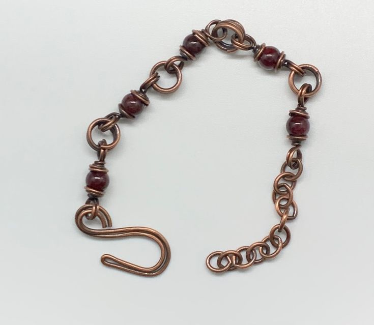 Handmade Double Copper Links Bracelet with deep red Garnet Beads.Adjustable from 6-7 1/2"This bracelet has been antiqued, polished and sealed.Sealed with Protectaclear ProtectaClear is a clear, protective coating that is tough enough to protect jewelry and is safe for wear against skin. ProtectaClear is practically invisible once applied and will seal and protect jewelry from tarnish, oxidation, and corrosion. Adjustable Burgundy Round Bead Bracelets, Adjustable Burgundy Bracelet, Copper Bracelet, Red Garnet, Deep Red, Infinity Bracelet, Link Bracelets, Garnet, Copper