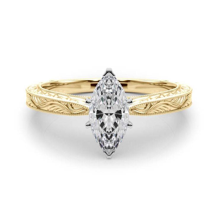 a yellow gold engagement ring with a pear shaped diamond