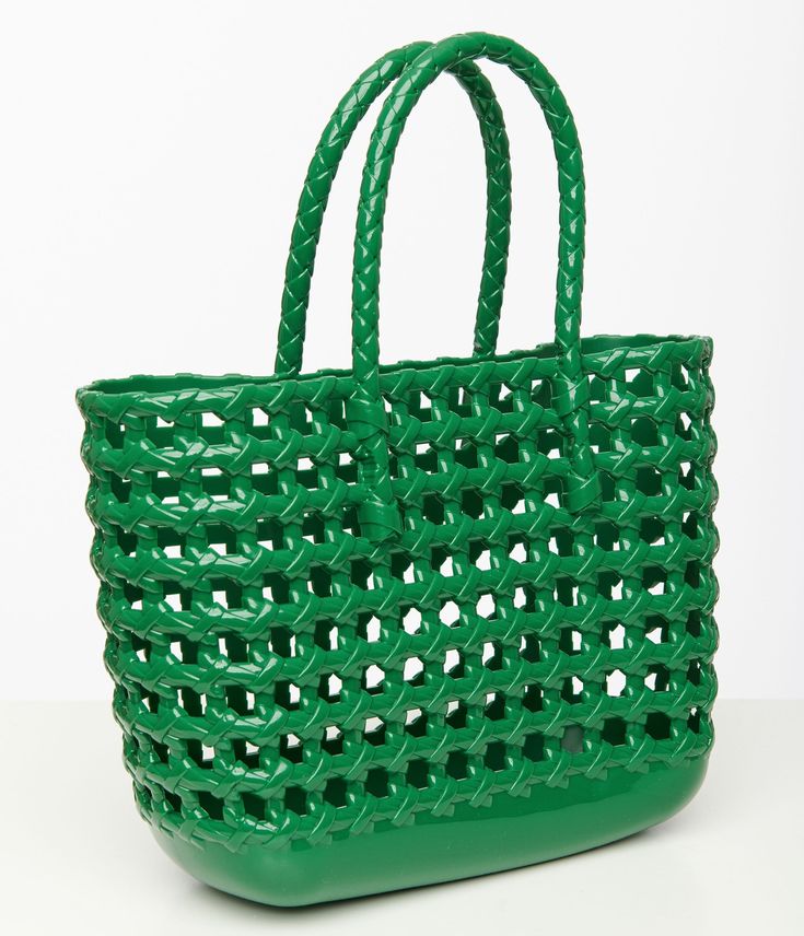 This green colored 1970s style handbag features a trendy net design that screams vintage vibes. With top handles for easy carrying, this bag is both stylish and practical.Available while supplies last. Green Bags With Braided Handles For On-the-go, Summer Green Shoulder Bag For On-the-go, Retro Green Shoulder Bag Satchel, Retro Green Shoulder Satchel, Retro Green Satchel Shoulder Bag, Retro Green Shoulder Bag For Errands, Green Retro Shoulder Bag For Errands, Vintage Green Satchel With Double Handle, Green Vintage Satchel With Double Handle