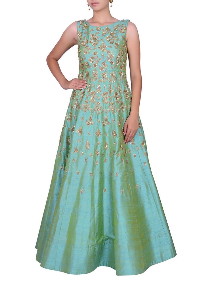 Featuring a sea green sleeveless flared gown made in raw silk accompanied by gold and silver floral sequin embroidery progressing from the top to the bottom. Color customization available upon request.Care:Dry Clean Only and to be Steam PressedComposition:Raw Silk