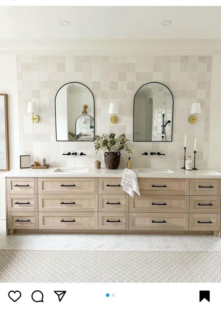 a bathroom with two sinks and mirrors on the wall