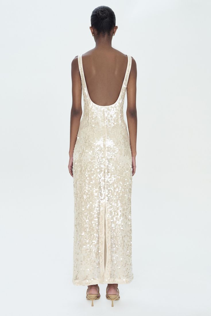 SUMMER 2024 WOMENS COLLECTION The Bex Dress in Champagne. This tank-style midi is adorned with a sea of sequins, catching the light for a subtle yet captivating sparkle. The sleeveless cut and gentle scoop neckline provide a tasteful simplicity, with a straight fit that elegantly traces the body�’s lines. SIMKHAI Women's Bex Dress in Champagne, Sequin, Size 10 January Jones, Reception Dress, End Of Season Sale, Wedding Outfits, Knitwear Tops, Denim Flares, Sneaker Heels, A Sea, British Indian