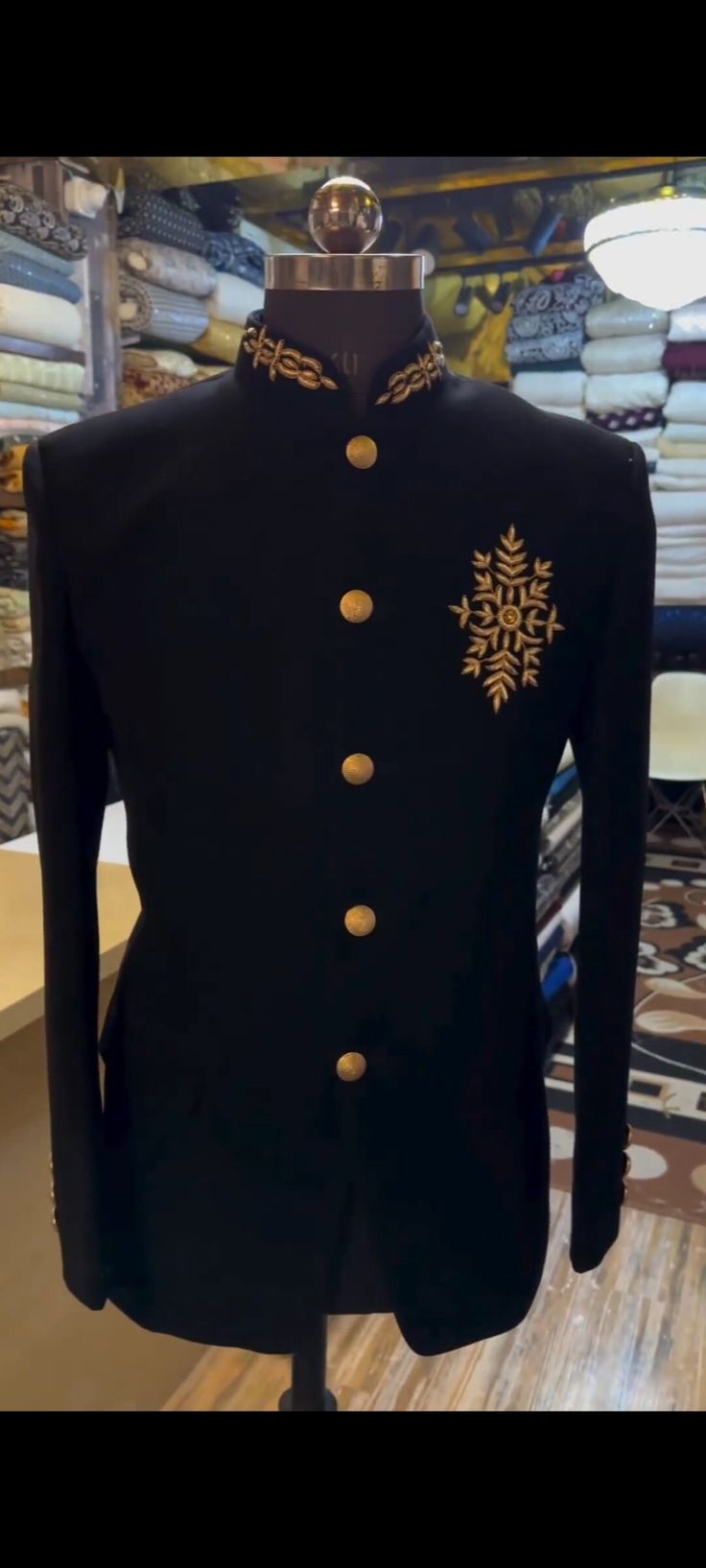 a black jacket with gold buttons on it