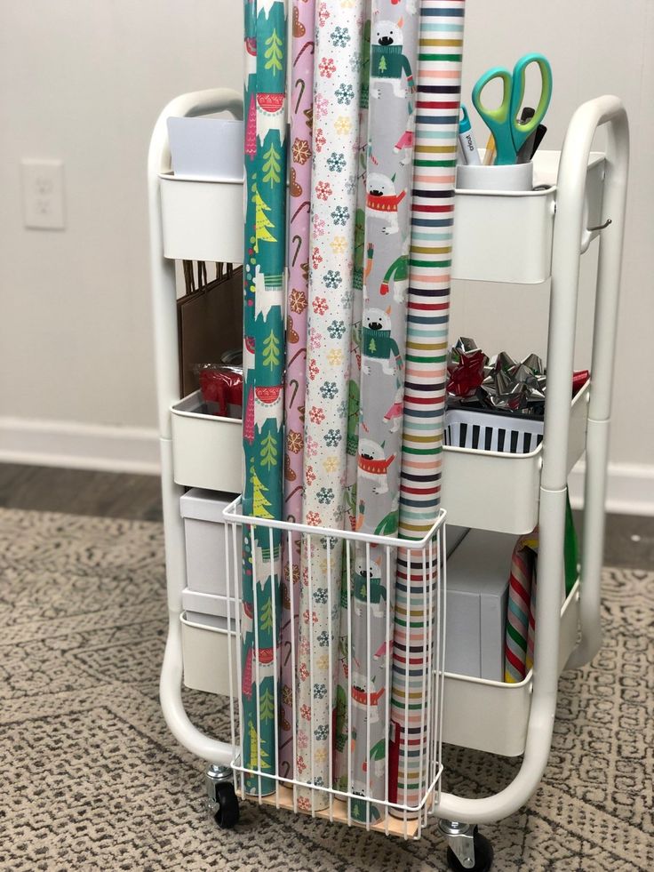 a cart filled with wrapping paper on top of a carpeted floor