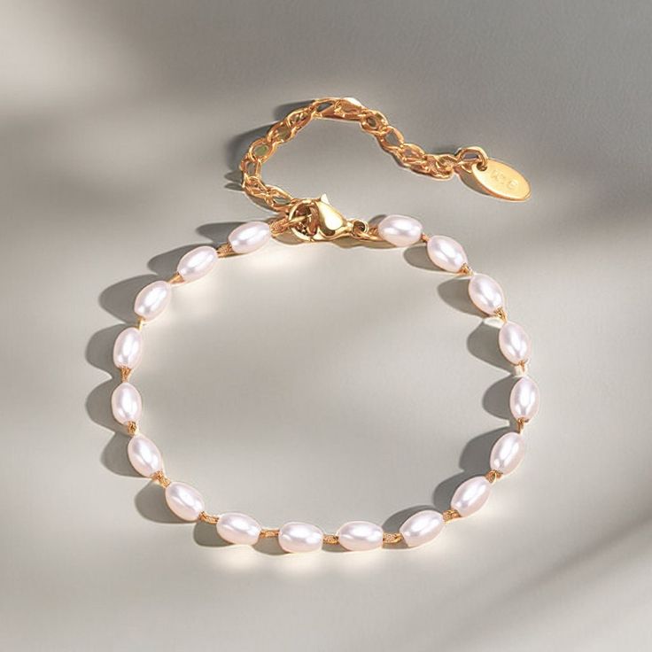 Elevate your wrist wear with our Elegant Oval Pearl Bracelet, a sophisticated piece that captures the essence of timeless elegance. This bracelet features lustrous oval-shaped pearls strung together with delicate craftsmanship, perfect for adding a touch of classic beauty to any attire. Key Features: - Oval Pearls: Exquisitely selected for their shape and radiance, each pearl brings a touch of sophistication. - Durable Clasp: Secured with a high-quality clasp for easy wear and lasting use. - - Versatile Style: The bracelet's simple yet elegant design complements both casual and formal looks. - Perfect Gift: Beautifully presented, it's an ideal gift for anniversaries, birthdays, or a special treat for yourself. Ordering Process: Select your preferred bracelet size, add to cart, and proceed Elegant Pearl Drop Chain Bracelet, Minimalist Metal Pearl Bracelet, Elegant Beaded Metal Bracelets With Pearl Charm, Metal Pearl Bracelet With Pearl Charm, Elegant Adjustable Chain Bracelet With Pearl Charm, Elegant Adjustable Pearl Charm Chain Bracelet, Elegant Metal Bracelets With Pearl Drop, Elegant Pearl Chain Bracelet With Pearl Drop, Elegant White Chain Bracelet With Pearl Charm