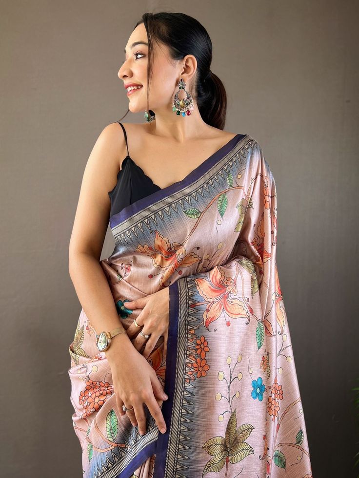 This stunning saree features a beautiful combination of peach and blue colors, adorned with intricate kalamkari print work that adds a traditional touch to the ensemble. The saree also comes with attached tassels on the pallu, adding a playful yet fashionable element to the overall look.
Crafted from high-quality silk fabric, this saree exudes a luxurious feel and drapes beautifully on the body. The similar color silk material blouse complements the saree perfectly, making it a complete traditio Pink Bohemian Pre-draped Saree For Festivals, Bohemian Banarasi Silk Saree, Traditional Multicolor Pre-draped Saree With Floral Print, Art Silk Saree With Dupatta In Peach, Peach Unstitched Saree Traditional Wear, Peach Semi-stitched Chanderi Saree, Unstitched Peach Saree Traditional Wear, Peach Art Silk Saree With Dupatta, Peach Semi-stitched Saree For Navratri