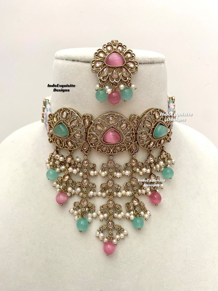 Elegant antique gold Polki pearls Choker Set with beautiful Jhumki earrings and Tikka/Indian Jewelry/ High quality kundan Polki jewelry/trendy choker/pink sky blue/pink surf  All items are shipped from Brampton, Ontario, Canada. If you need your item by a certain day, please reach out to us for express delivery option before placing the order so that we can update the shipping for you. Standard shipping/delivery timeline Below are the estimated delivery times after the order is shipped/dispatche Pink Kundan Jewelry With Intricate Design, Festive Pink Jewelry With Intricate Design, Pink Intricate Jewelry For Diwali, Pink Kundan Necklace With Intricate Design, Bollywood Style Jeweled Pink Jewelry, Polki Choker Set, Pearls Choker, Polki Choker, Brampton Ontario