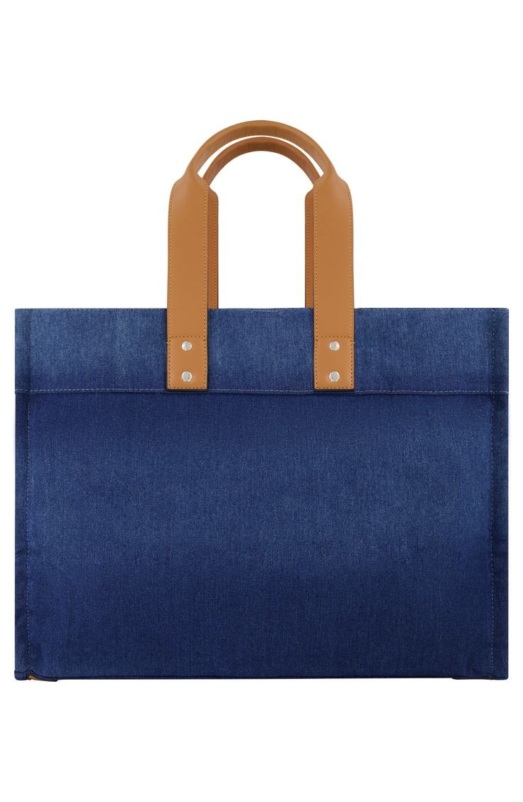 Show off signature style with this washed denim tote bag constructed with rolled shoulder straps and a roomy interior. 13.5" x 18" x 8" 8" strap drop Magnetic snap closure Dual shoulder straps Exterior with 1 slip pocket Interior with 3 slip pockets; 1 zip pocket Textile lining Textile Imported Jeans Large, Denim Tote Bags, Denim Tote, Washed Denim, Brand Jeans, Jeans Brands, True Religion, Signature Style, Denim Wash