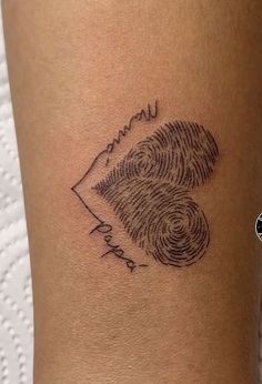 a woman's arm with a fingerprint tattoo on it