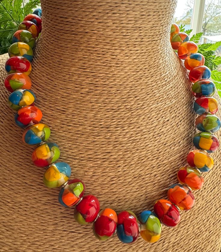 Colourful bead Necklace featuring Red, Blue, Green & Yellow Resin beads. Fastens with hook. Measurements: HANDMADE & FAIRTRADE Items posted to addresses within the UK will be sent Royal Mail 1st Class UK Standard. International post will be sent Royal Mail International Tracked. Multicolor Czech Glass Oval Bead Necklace, Multicolor Czech Glass Necklaces With Oval Beads, Colorful Adjustable Necklaces With Round Beads, Multicolor Czech Glass Necklace With Oval Beads, Colorful Necklaces With Faceted Round Beads, Colorful Faceted Round Bead Necklaces, Multicolor Necklaces With Spacer And Round Beads, Red Glass Beaded Necklaces With Polished Beads, Red Glass Necklace With Spacer Beads